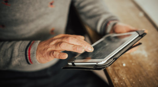 Man's hand using a tablet device