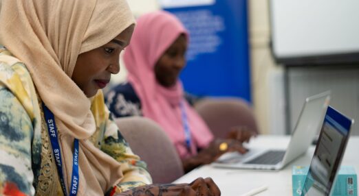 Two women using laptops